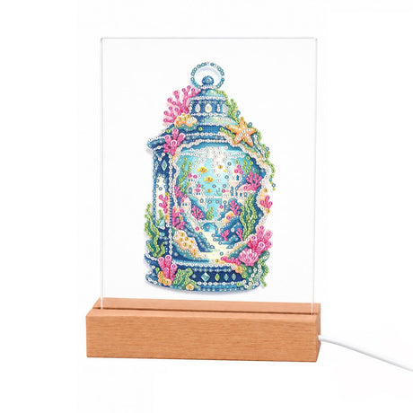 Coral Reef in a Blue Lantern light-up pearl painting – Ornate blue lantern holding an underwater scene of coral, seaweed, starfish and a tiny waterfall