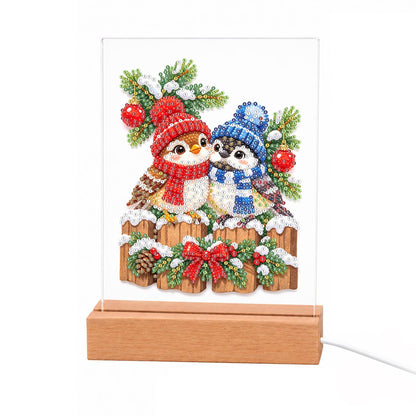 Winter Birds in Knit Bobble Hats light-up pearl painting – Two little birds in red and blue knit hats and scarves on a snowy fence with holly, pine and a red bow