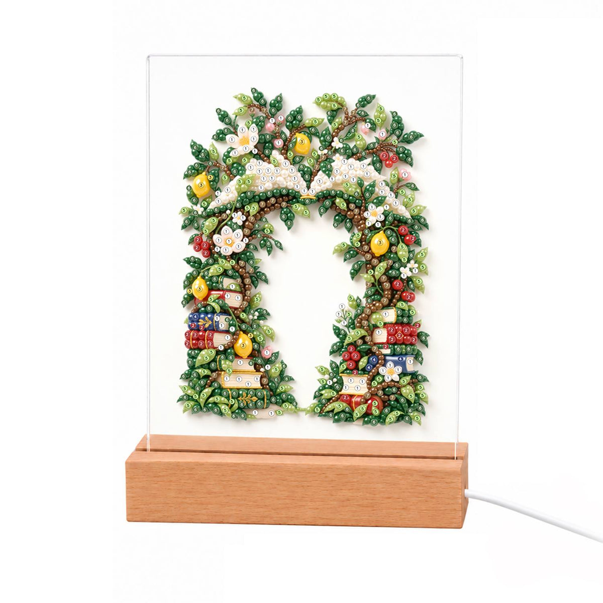 Book-Lined Garden Archway light-up pearl painting – Leafy green archway with white and yellow blossoms and stacks of books tucked along both sides