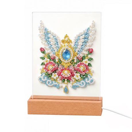 Winged Sapphire and Pink Roses light-up pearl painting – Blue gemstone set in gold between white and blue angel wings above pink and red roses