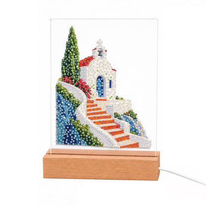 Clifftop Chapel and Red Stairway light-up pearl painting – Small white chapel with a cross on a seaside cliff, reached by red-orange steps beside a tall cypress