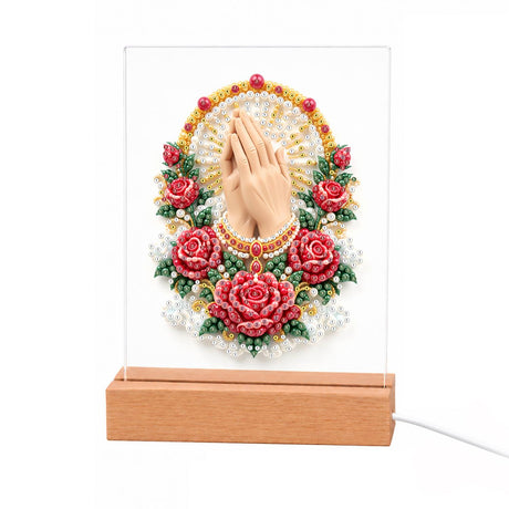 Praying Hands in a Rose Garland light-up pearl painting – Praying hands inside a gold oval halo, framed by red roses, white flowers and green leaves