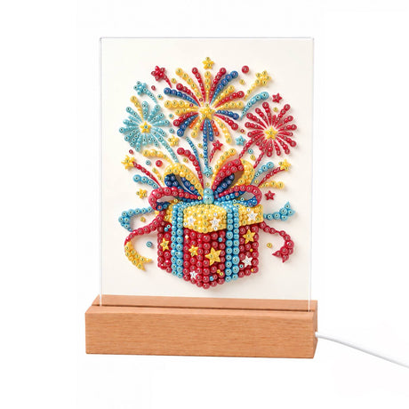 Gift Box Bursting with Fireworks light-up pearl painting – Red gift box with gold stars and a blue ribbon bursting with colorful fireworks and confetti