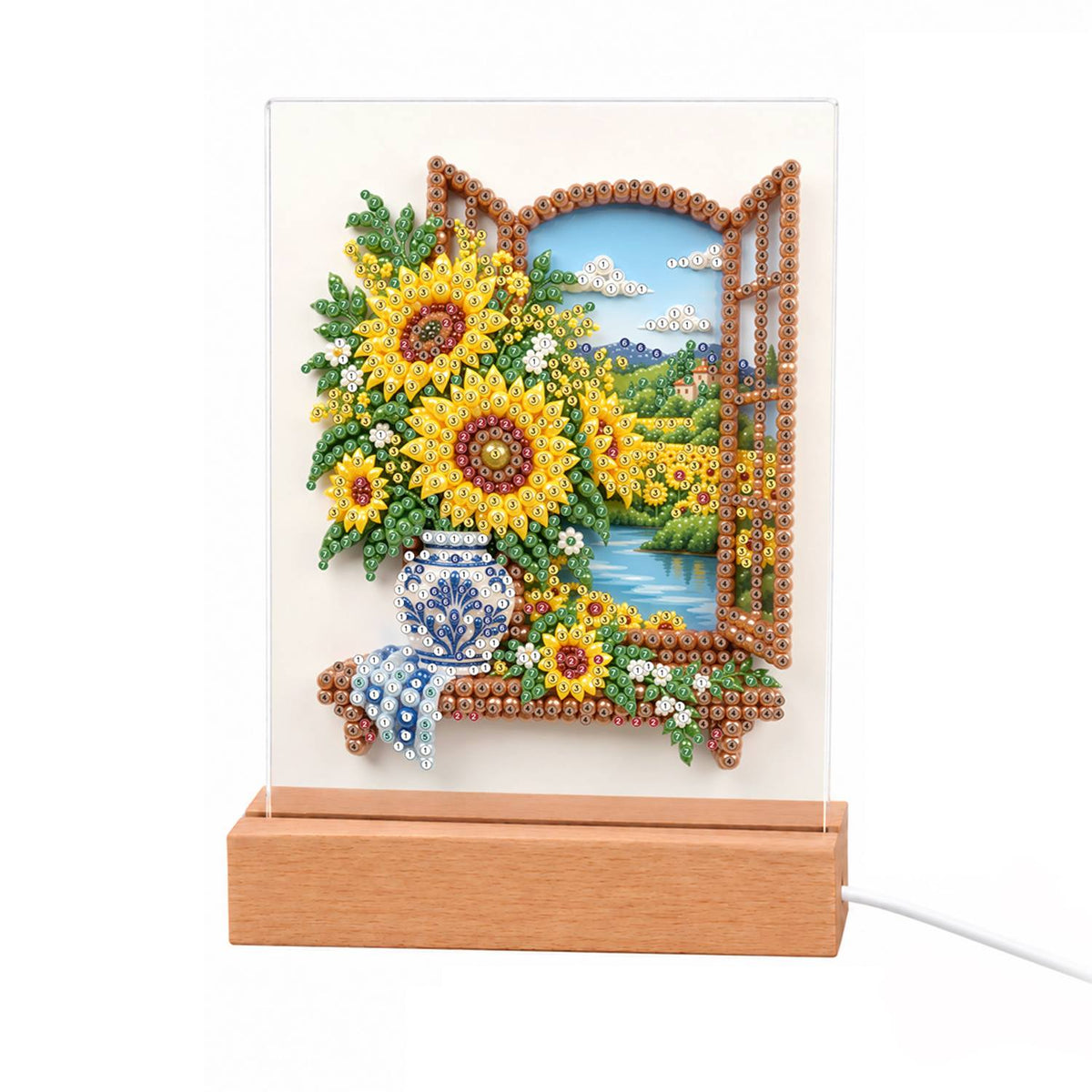 Sunflowers at a Lakeside Window light-up pearl painting – Sunflowers in a blue-and-white vase on a sill by an open wooden window overlooking a lake and fields