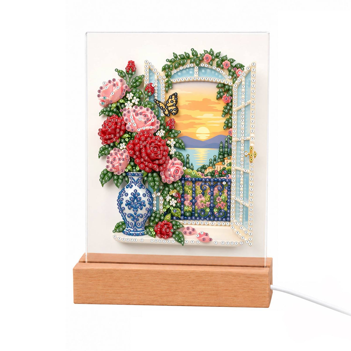 Roses by a Seaside Balcony light-up pearl painting – Pink and red roses in a blue-and-white vase by an open balcony window at sunset over the sea, with a butterfly