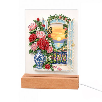 Roses by a Seaside Balcony light-up pearl painting – Pink and red roses in a blue-and-white vase by an open balcony window at sunset over the sea, with a butterfly