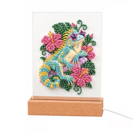 Turquoise Lizard in Pink Hibiscus light-up pearl painting – Turquoise lizard with a curled tail among pink hibiscus flowers and green leaves