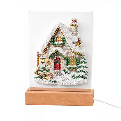 Snow-Laden Cottage with Gold Trim light-up pearl painting – Cream cottage heavy with snow, gold-trimmed roof, red door, glowing lantern, gold fence and pine tree