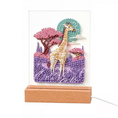 Giraffe in a Lavender Savanna light-up pearl painting – Giraffe standing in purple grass among pink-crowned trees under a pale moon