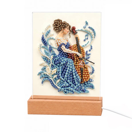 Cellist in a Sapphire Gown light-up pearl painting – Woman in a blue gown playing a cello, surrounded by blue and white swirling leaves