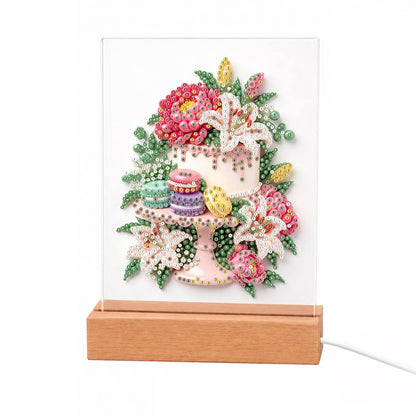 Lily-Topped Cake with Macarons light-up pearl painting – White layered cake on a stand with macarons, pink peonies and white lilies