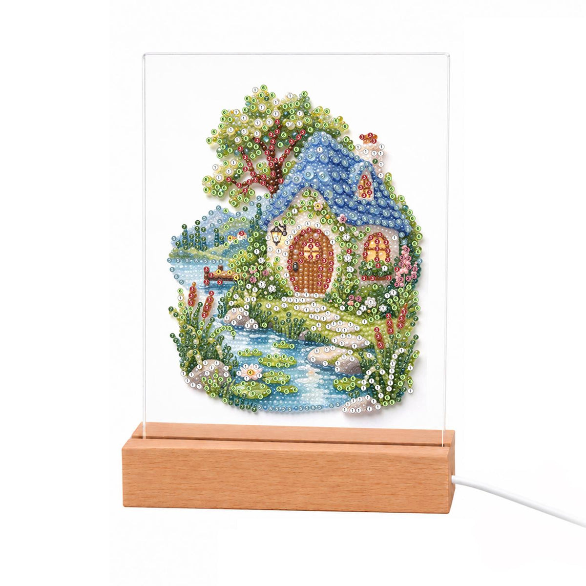 Blue-Roofed Cottage by a Stream light-up pearl painting – Cottage with a blue rounded roof and arched wooden door beside a stream, a leafy tree and wildflowers