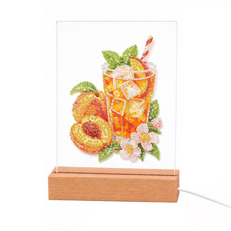 Iced Peach Tea with Blossoms light-up pearl painting – Glass of orange iced peach tea with a striped straw beside halved peaches and pink blossoms