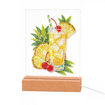 Pineapple Lemonade with Cherries light-up pearl painting – Yellow lemonade with ice, a striped straw and a cherry, beside lemon slices, pineapple and red cherries