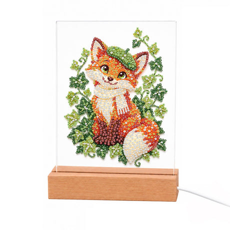 Fox in a Green Beret light-up pearl painting – Smiling fox in a green beret and cream scarf sitting in a wreath of green ivy leaves