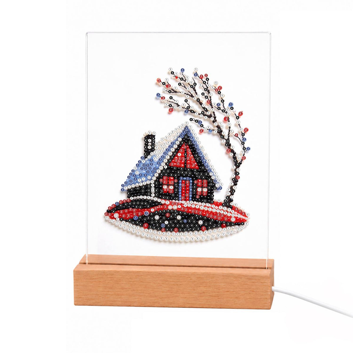 Red Cabin on a Snowy Hill light-up pearl painting – Small red and black cabin with a snow-covered roof on a hill beside bare winter branches