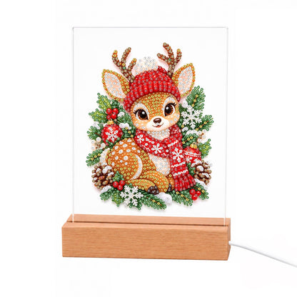 Fawn in a Red Nordic Scarf light-up pearl painting – Fawn in a red pompom hat and Nordic scarf resting among holly, pinecones and snowflakes