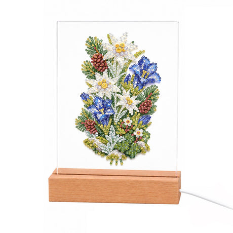Edelweiss and Blue Gentians light-up pearl painting – White edelweiss stars and blue gentian flowers with pine sprigs and small pinecones