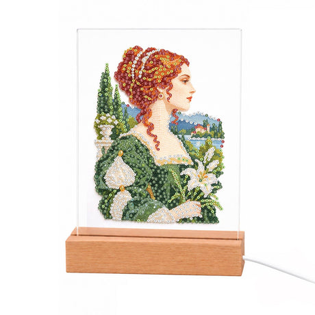 Red-Haired Lady with Calla Lilies light-up pearl painting – Red-haired woman with jewels in her updo, in a green gown holding white calla lilies before a lakeside garden