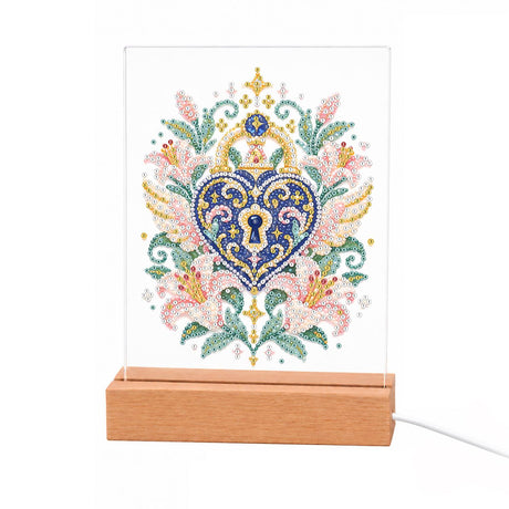 Heart Padlock in Pink Lilies light-up pearl painting – Blue heart-shaped padlock with a keyhole and gold filigree crown, framed by pink lilies and teal leaves