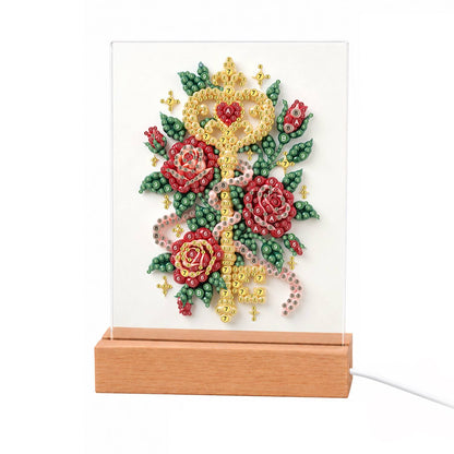 Golden Key Among Red Roses light-up pearl painting – Ornate golden key with a heart-shaped bow entwined with red roses, green leaves and a pink ribbon