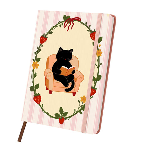 Bookworm Cat in a Berry Wreath paint by numbers notebook – Black cat reading a book in a peach armchair inside a strawberry vine wreath on pink stripes, pink notebook