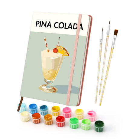 Coconut Cream Cocktail on Sage paint by numbers notebook – Creamy pineapple and coconut cocktail with a cherry, pineapple wedge and striped straw on sage green, pink notebook