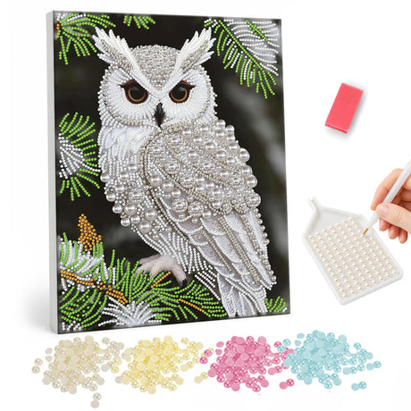 Snowy Owl on Pine Branch pearl painting – White snowy owl with amber eyes perched on a pine branch