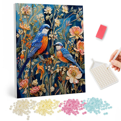 Bluebird Pair in Night Garden pearl painting – Two blue and orange songbirds perched among pale peach flowers and leaves on a deep blue background