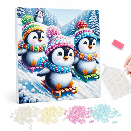 Three Penguins on Sleds pearl painting – Three penguins in colorful knit hats and scarves sledding down a snowy hill