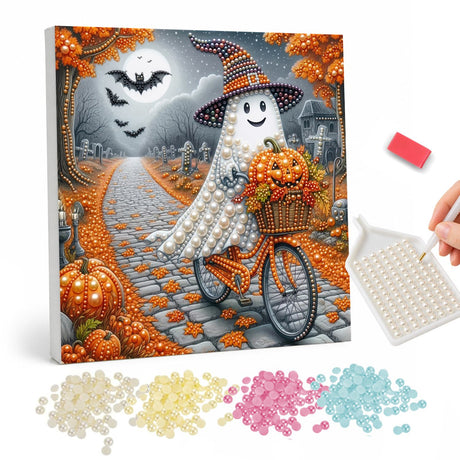 Ghost Cycling the Autumn Lane pearl painting – Ghost in a witch hat riding a bicycle with a basket of pumpkins down a leaf-strewn cobbled lane at night