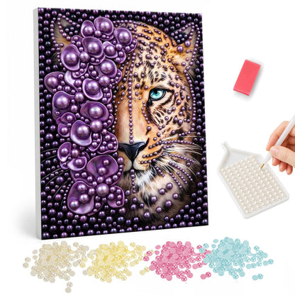 Half-Purple Leopard Face pearl painting – Leopard face with blue-green eyes, half covered in clustered purple beads on a dark purple background