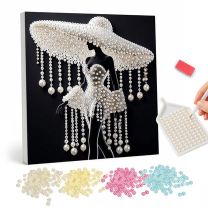 Lady Under a Beaded Sun Hat pearl painting – White silhouette of an elegant woman in a wide-brimmed hat hung with bead strands, on black
