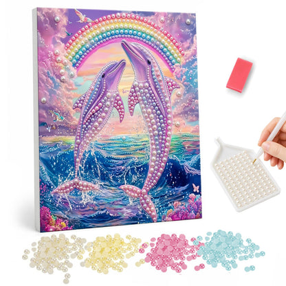 Leaping Dolphins Under a Rainbow pearl painting – Two lilac dolphins leaping from sparkling waves beneath a rainbow and pink sunset clouds