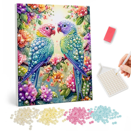 Lovebirds in a Flower Arch pearl painting – Two turquoise parrots with pink and purple heads facing each other among bright flowers
