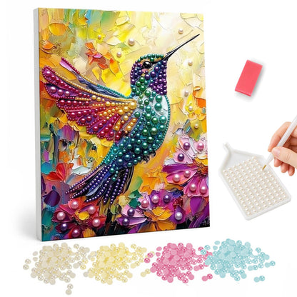 Emerald Hummingbird in Sunlight pearl painting – Emerald and teal hummingbird with spread wings over purple flowers against thick golden brushstrokes