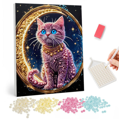 Jeweled Kitty and Crescent Moon pearl painting – Pink cat with blue eyes and a gold collar sitting within a golden crescent moon ring on a starry sky