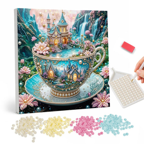 Teacup Kingdom with Waterfalls pearl painting – Ornate teal teacup holding a tiny castle and glowing village, with waterfalls and pink flowers around