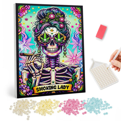 Skeleton Diva with a Flower Bun pearl painting – Skeleton woman with flowers in her hair and leaf-print sunglasses holding a smoke, with a banner, on teal