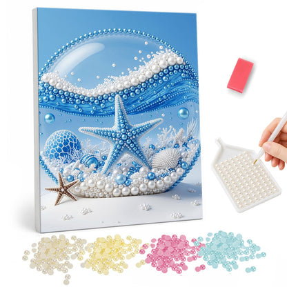 Blue Starfish in a Glass Dome pearl painting – Blue starfish and shells inside a glass sphere with a curling blue wave, a small starfish on the sand outside