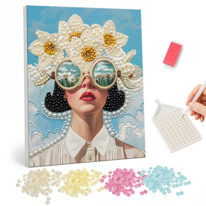 Daisy-Crowned Lady in Round Shades pearl painting – Woman with dark hair, red lips and round sunglasses reflecting mountains, crowned with big white daisies
