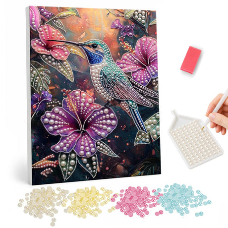 Hummingbird in Twilight Hibiscus pearl painting – Silvery teal hummingbird perched among large pink and purple hibiscus on a dark garden background