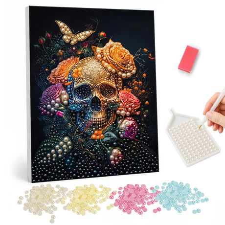 Golden Skull with a Butterfly pearl painting – Gold-toned skull crowned with peach and purple roses and a golden butterfly on a black background