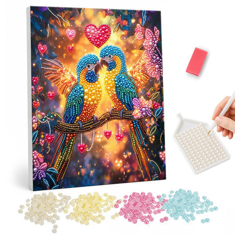 Macaw Sweethearts Under Red Hearts pearl painting – Two blue and gold macaws touching beaks on a branch beneath floating red hearts and warm bokeh