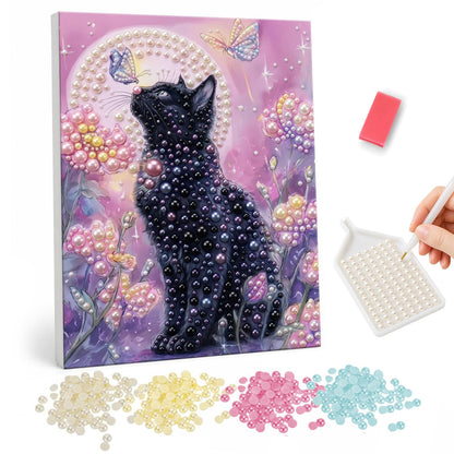 Midnight Kitty in Pink Blossoms pearl painting – Black cat sitting among pink blossoms and gazing up at butterflies on a soft lilac background