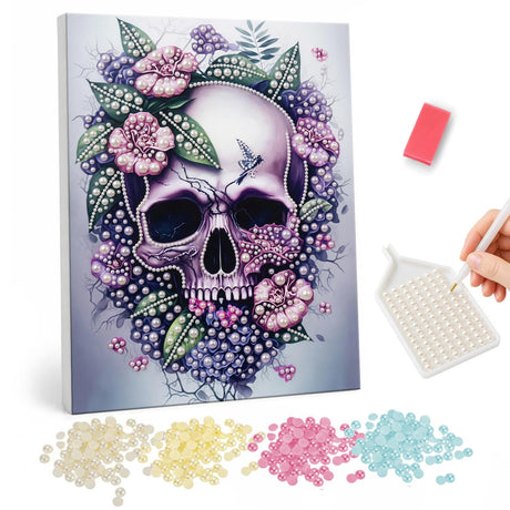 Lilac Skull in a Flower Wreath pearl painting – Pale purple skull wreathed in pink flowers, green leaves and purple berries on a lilac background