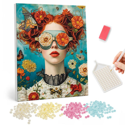 Redhead in Rose-Lens Goggles pearl painting – Red-haired woman with orange flowers in her curls, teal goggles with cream rose lenses and a lace collar