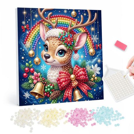 Rainbow Fawn with Golden Bells pearl painting – Big-eyed antlered fawn with a red plaid bow and gold bells under a rainbow on a starry blue background