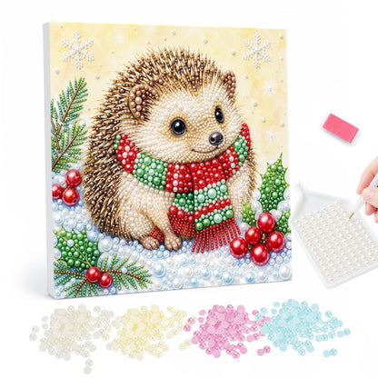 Hedgehog in a Striped Scarf pearl painting – Hedgehog in a red and green striped scarf sitting in snow with holly and red berries