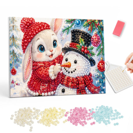 Bunny Building a Snowman pearl painting – White bunny in a red hat and sweater placing a carrot nose on a top-hatted snowman